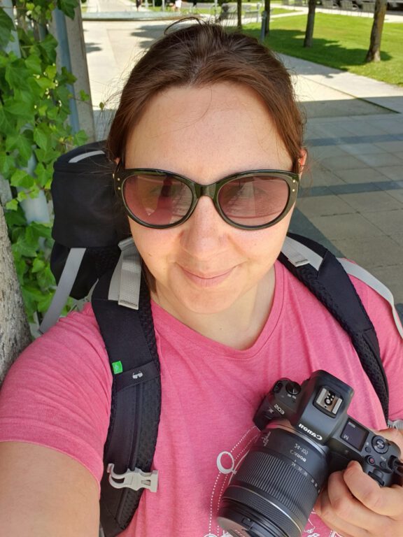 Ich mit rosa Shirt, Haare zusammengebunden, schaue ich die Handykamera und halte meine Canon in der Hand